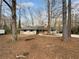 House exterior showcasing a large front yard and mature trees at 130 Ashley Oaks Dr, Mcdonough, GA 30253