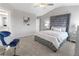 Spacious main bedroom with gray upholstered bed, carpeted floor, and a walk in closet at 11682 Chatham Dr, Hampton, GA 30228