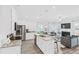 Open concept kitchen with island, stainless steel appliances, and granite countertops at 11682 Chatham Dr, Hampton, GA 30228