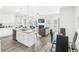 Kitchen and dining area with glass table and chairs, hardwood flooring and open floor plan at 11682 Chatham Dr, Hampton, GA 30228