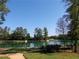 Serene pond with walking path, lush greenery, and clear blue sky at 11682 Chatham Dr, Hampton, GA 30228