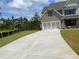 Large concrete driveway leading to a two story home at 4708 Cooling Water Circle, Powder Springs, GA 30127