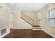 Elegant staircase with a wooden handrail and carpeted steps at 169 Barone Nw Pl, Atlanta, GA 30327