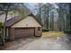 Attached garage with brown overhead door and brick exterior at 2929 Glad Dale Se Dr, Conyers, GA 30094