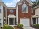 Front view of charming brick townhouse with garage at 2708 Parkway Trl, Lithonia, GA 30058