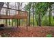 Elevated deck overlooks wooded backyard with a view of a lake at 340 Sir Richard Ct, Jonesboro, GA 30236