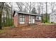 Brick ranch home with a landscaped yard and driveway at 340 Sir Richard Ct, Jonesboro, GA 30236
