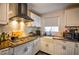 Updated kitchen with white cabinets and hexagon tile backsplash at 340 Sir Richard Ct, Jonesboro, GA 30236