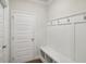 Functional mudroom with built-in bench and hooks at 506 Se Sageton Ct, Lawrenceville, GA 30045