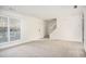 Bright living room with neutral carpeting and stairs at 6674 Eastbriar Dr, Lithonia, GA 30058