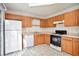 Kitchen features wood cabinets, gas range and dishwasher at 6674 Eastbriar Dr, Lithonia, GA 30058