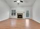 Living room with wood floors, a stone fireplace, and access to a back deck at 76 Cedars Glen Cir, Villa Rica, GA 30180