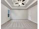 Spacious main bedroom with carpeted floors, a tray ceiling, and neutral walls at 76 Cedars Glen Cir, Villa Rica, GA 30180