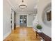 Bright entryway with hardwood floors and elegant chandelier at 230 Pebble Trl, Alpharetta, GA 30009