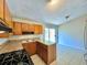 Bright kitchen featuring wood cabinets, gas range, and access to backyard at 650 Lyric Nw Way, Atlanta, GA 30318
