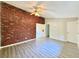 Spacious living room with brick wall and ceiling fan at 650 Lyric Nw Way, Atlanta, GA 30318
