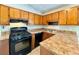 Galley kitchen with wood cabinets and appliances at 650 Lyric Nw Way, Atlanta, GA 30318