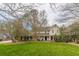 Two-story house with a large front yard and mature trees at 380 Stone Mill Trl, Atlanta, GA 30328