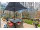 Deck with outdoor seating and a view of the wooded backyard at 380 Stone Mill Trl, Atlanta, GA 30328