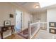 Upper hallway with skylight, white railing and hardwood floors at 380 Stone Mill Trl, Atlanta, GA 30328