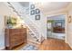 Elegant entryway with hardwood floors, staircase, and antique furniture at 380 Stone Mill Trl, Atlanta, GA 30328