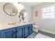 Bathroom with double vanity, blue cabinets, and updated fixtures at 380 Stone Mill Trl, Atlanta, GA 30328