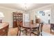 Elegant dining room with a large table, chandelier, and built-in hutch at 380 Stone Mill Trl, Atlanta, GA 30328