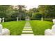 Landscaped backyard with stone pathway leading to a pool and charming gazebo at 4665 Riverview Rd, Atlanta, GA 30327