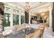 Luxurious main bedroom with sitting area, large windows, and elegant chandelier at 4665 Riverview Rd, Atlanta, GA 30327