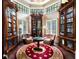 Cozy library with built-in bookshelves, leather armchairs, and ornate rug at 4665 Riverview Rd, Atlanta, GA 30327