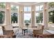 Sunroom with two sofas, large windows, and stunning views at 4665 Riverview Rd, Atlanta, GA 30327