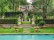 Landscaped gardens with stone steps, statues, and wrought iron fencing at 4665 Riverview Rd, Atlanta, GA 30327