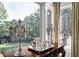 Sitting room with large windows overlooking the backyard, and antique furniture at 4665 Riverview Rd, Atlanta, GA 30327