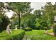 Landscaped grounds with lush greenery, stonework and garden statues at 4665 Riverview Rd, Atlanta, GA 30327