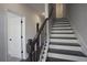 Modern staircase with dark wood and metal railing at 577 Fundao Ln # 14, Lawrenceville, GA 30046
