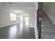 Open living room with hardwood floors and large windows at 577 Fundao Ln # 14, Lawrenceville, GA 30046
