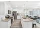 Open concept kitchen and living area with island and hardwood floors at 11638 Chatham Dr, Hampton, GA 30228