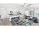 Open concept kitchen and living room with island and grey sofas at 11638 Chatham Dr, Hampton, GA 30228