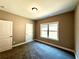 Bright bedroom with carpet, window, and two doors at 22 Stratford Way, Kingston, GA 30145