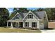 Two-story house with gray siding, stone accents, and a front porch at 22 Stratford Way, Kingston, GA 30145