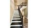 Elegant staircase with dark wood and metal railing at 22 Stratford Way, Kingston, GA 30145