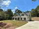 Two-story house with gray siding, stone accents, and a front porch at 22 Stratford Way, Kingston, GA 30145
