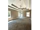 Spacious bedroom with carpeted floor and tray ceiling at 22 Stratford Way, Kingston, GA 30145