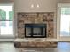 Modern fireplace with a stone surround in a living room at 22 Stratford Way, Kingston, GA 30145
