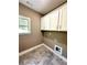 Laundry room with white cabinets and tile flooring at 22 Stratford Way, Kingston, GA 30145