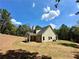 Two-story house with gray siding, stone accents, and a covered patio at 22 Stratford Way, Kingston, GA 30145