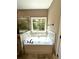 Relax in this spa-like bathroom, featuring a soaking tub and a walk-in shower at 22 Stratford Way, Kingston, GA 30145