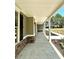 Covered front porch offers a relaxing outdoor space at 22 Stratford Way, Kingston, GA 30145