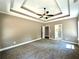 Spacious bedroom with carpeted floor, tray ceiling and access to bathroom at 22 Stratford Way, Kingston, GA 30145
