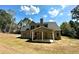 Two-story house with gray siding, stone accents, and a covered patio at 22 Stratford Way, Kingston, GA 30145